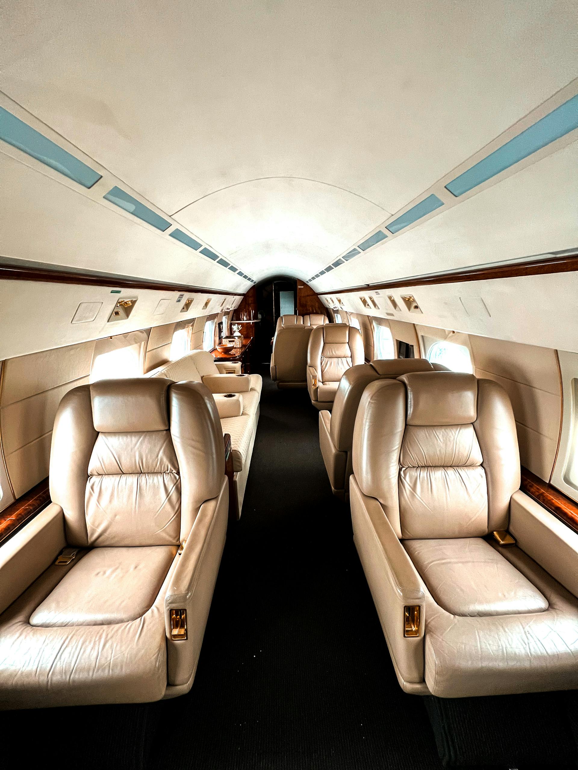Luxury private jet interior with leather seats and ambient lighting
